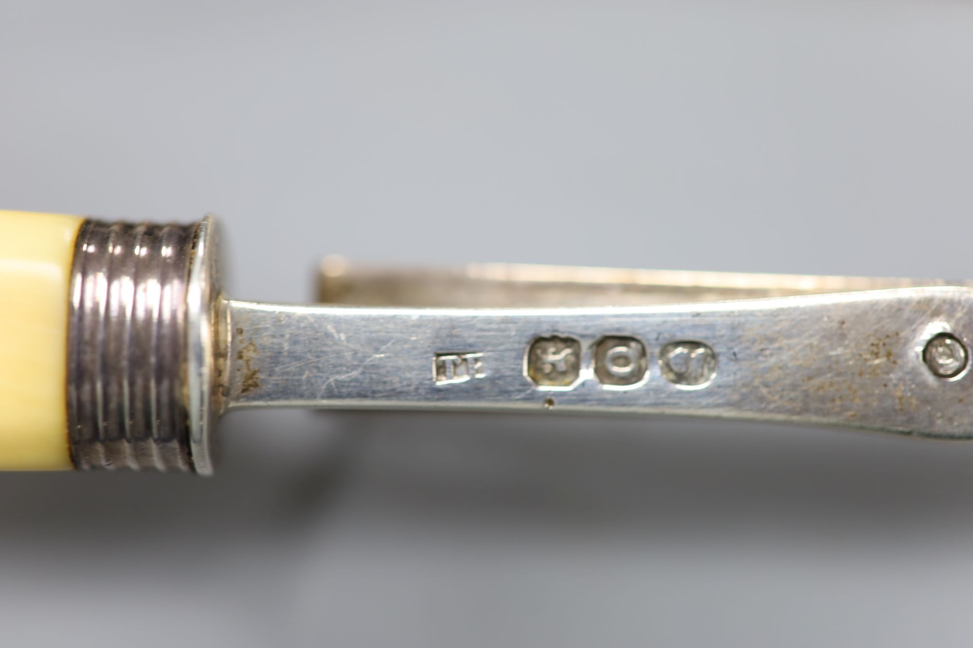 A George III ivory-handled silver cheese scoop, London, 1811, 26.4cm, a silver-handled ivory page turner and a modern silver snuffer
